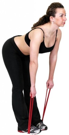 Übung mit einem Gummiband für Fitness. Übungen für den ganzen Körper, Beine, Gesäß, für die Presse von Frauen